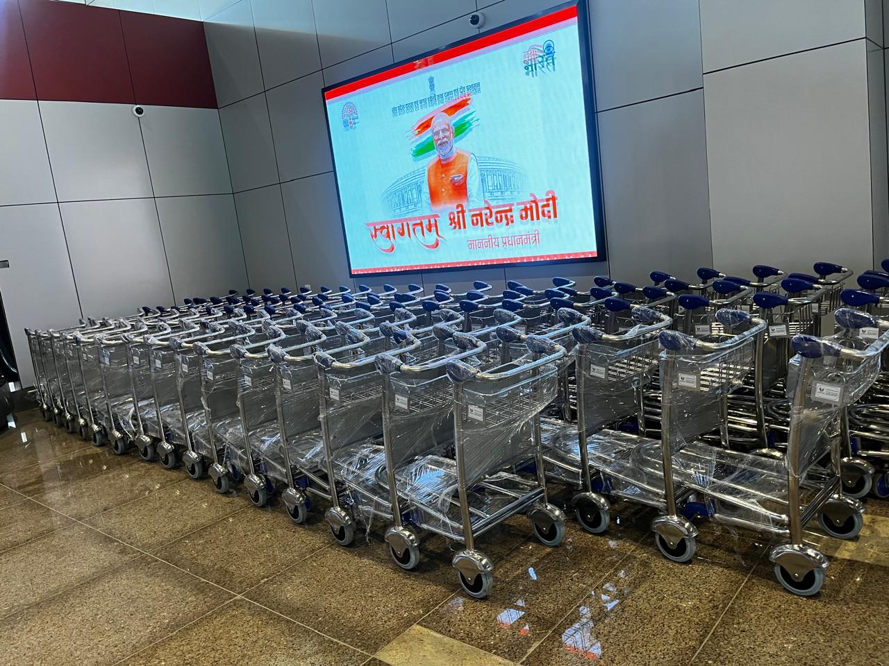 Shrink-wrapped airport baggage trolleys installed at airport terminal ready for use
